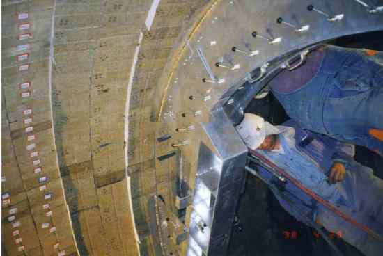 Image showing men installing a new brick lining in a cement kiln.